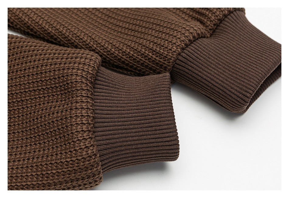 Close-up of brown knit jacket sleeves and ribbed cuffs.