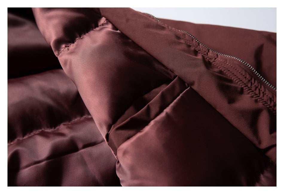 Close-up of the burgundy jacket's inner lining, seam, and zipper.