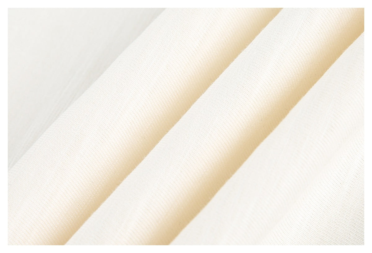 Close-up of ivory fabric showing its fine, subtle knit texture.
