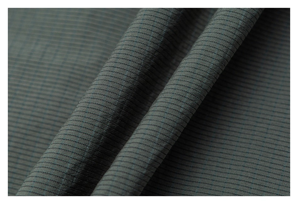 Close-up of draped gray-green fabric with fine, closely spaced dark horizontal stripes.