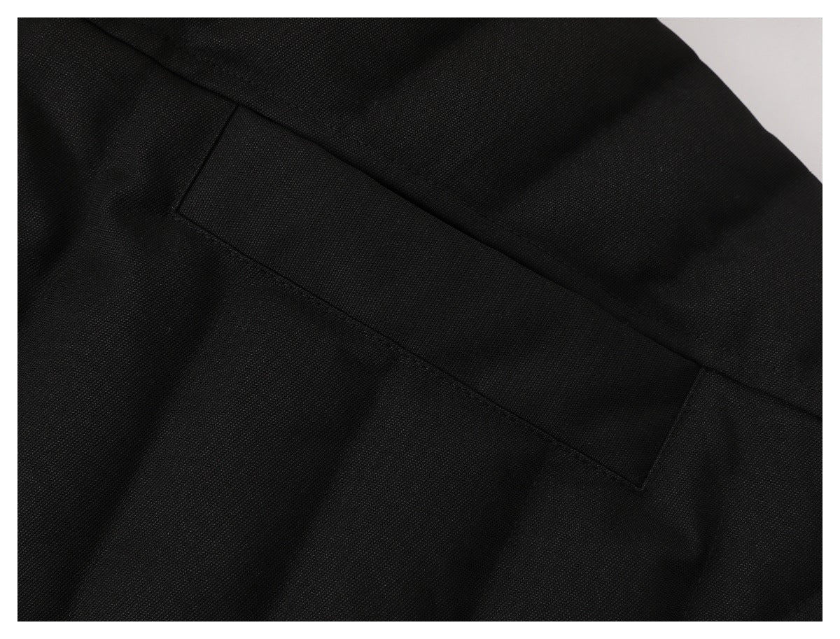 Close-up of black garment fabric with a long rectangular stitched panel.
