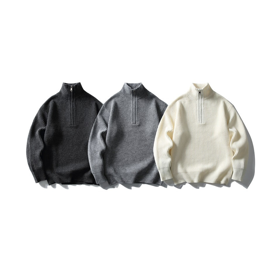 Three rib-knit quarter-zip sweaters arranged front-facing in charcoal, gray, and cream.