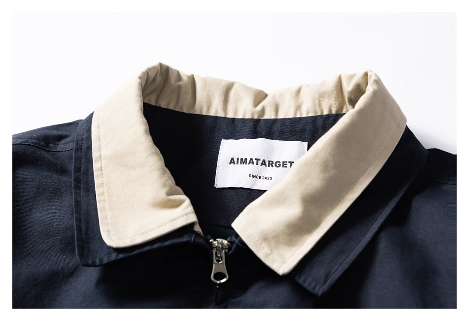 Close-up of the jacket's beige collar, front zipper, and sewn neck label.