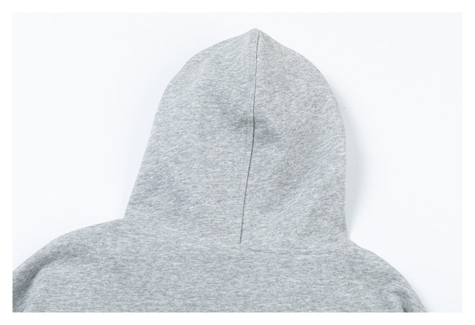 Close-up of the back of a light gray hood, showing its center seam and shoulder area.
