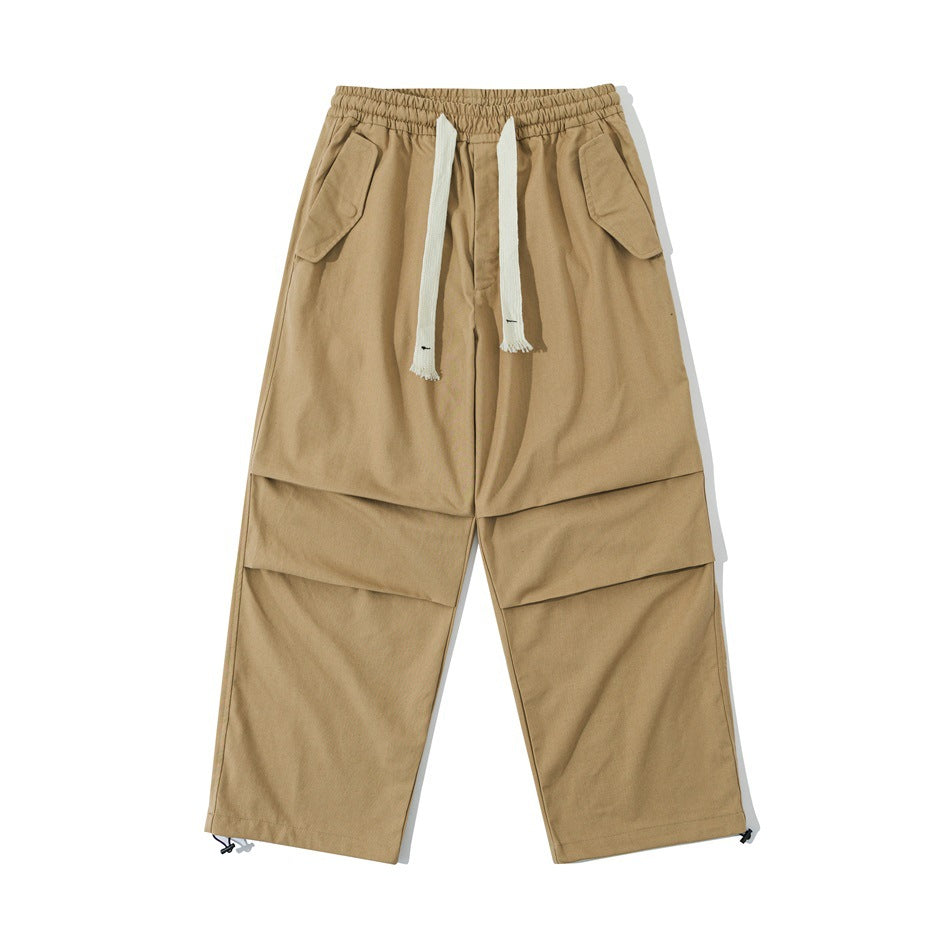 Khaki wide-leg drawstring pants with hip flap pockets, knee pleats and hem toggles, front flat view