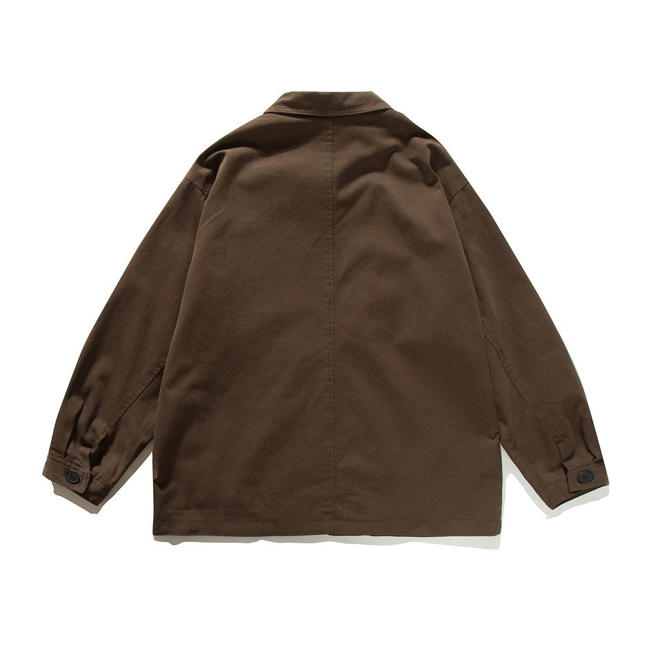 Back view of brown chore jacket with center back seam and buttoned cuffs, flat lay