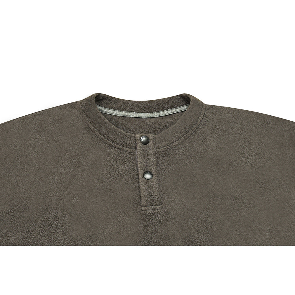 Close-up of an olive-gray fleece pullover neckline with a two-snap front placket.