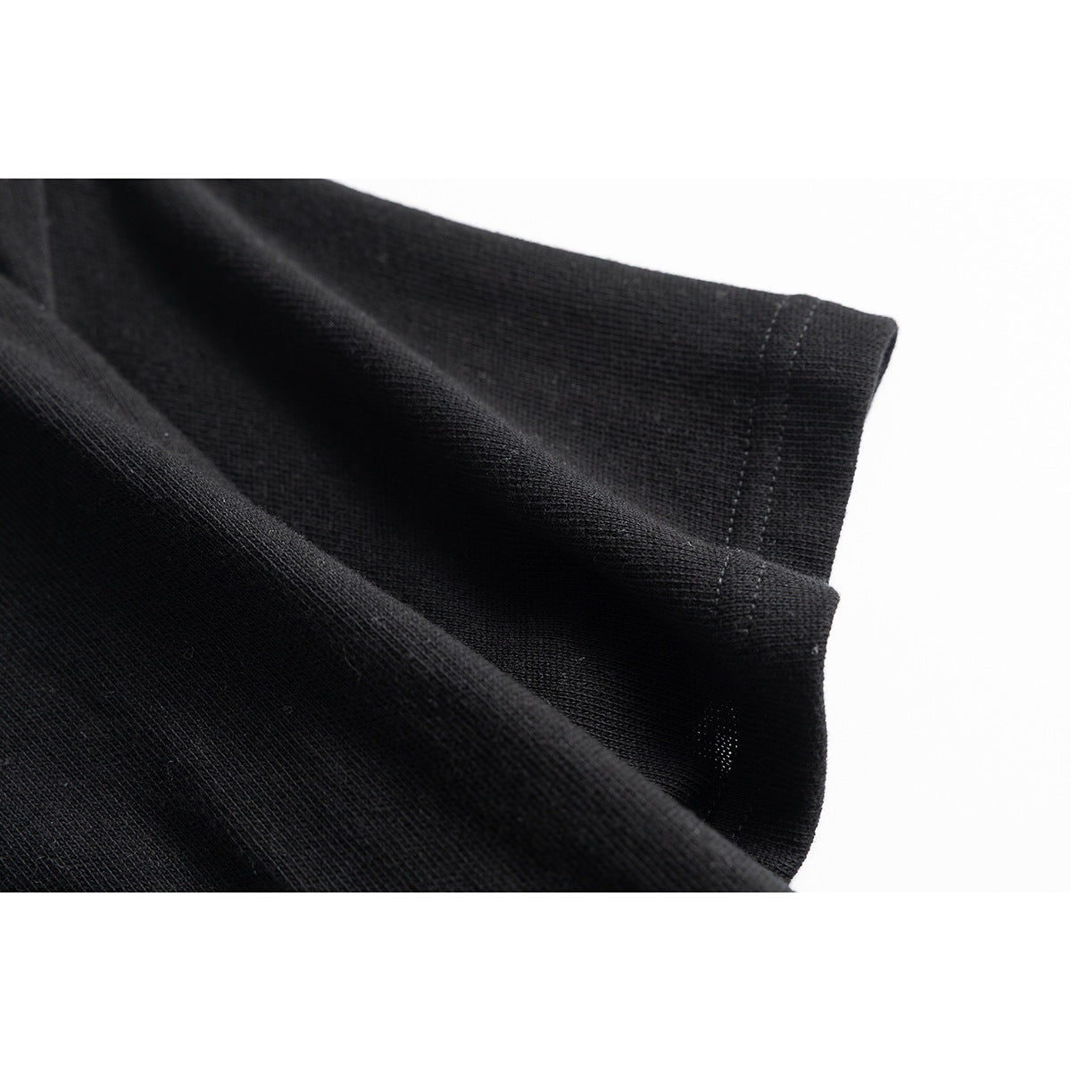 Close-up of a black short sleeve and stitched hem.