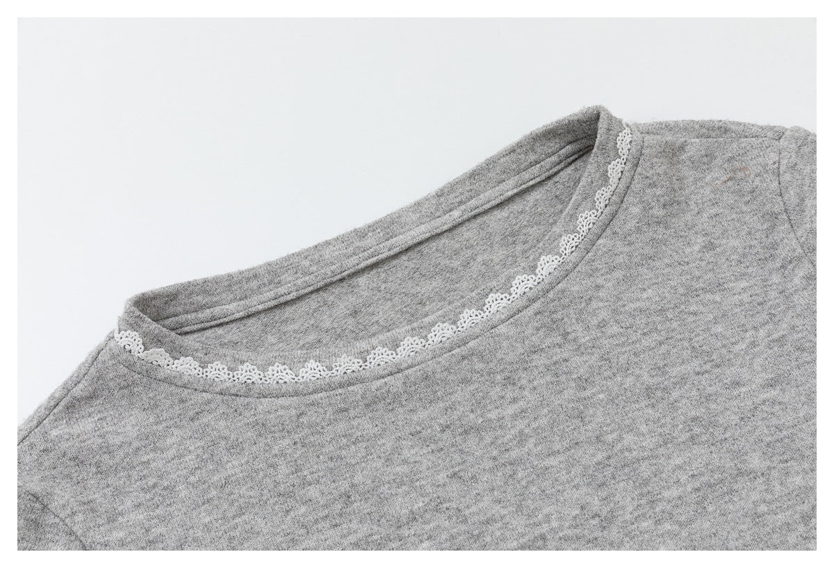 Close-up of the gray top's rounded neckline with delicate white lace trim.