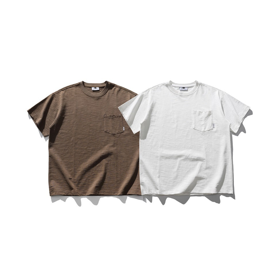 Brown and white short-sleeve crew-neck T-shirts, each with a chest pocket, shown from the front.