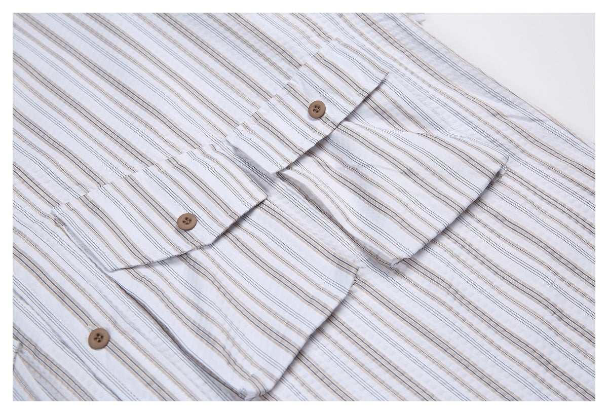 Close-up of the striped shirt's brown buttons, front placket, and chest pocket.
