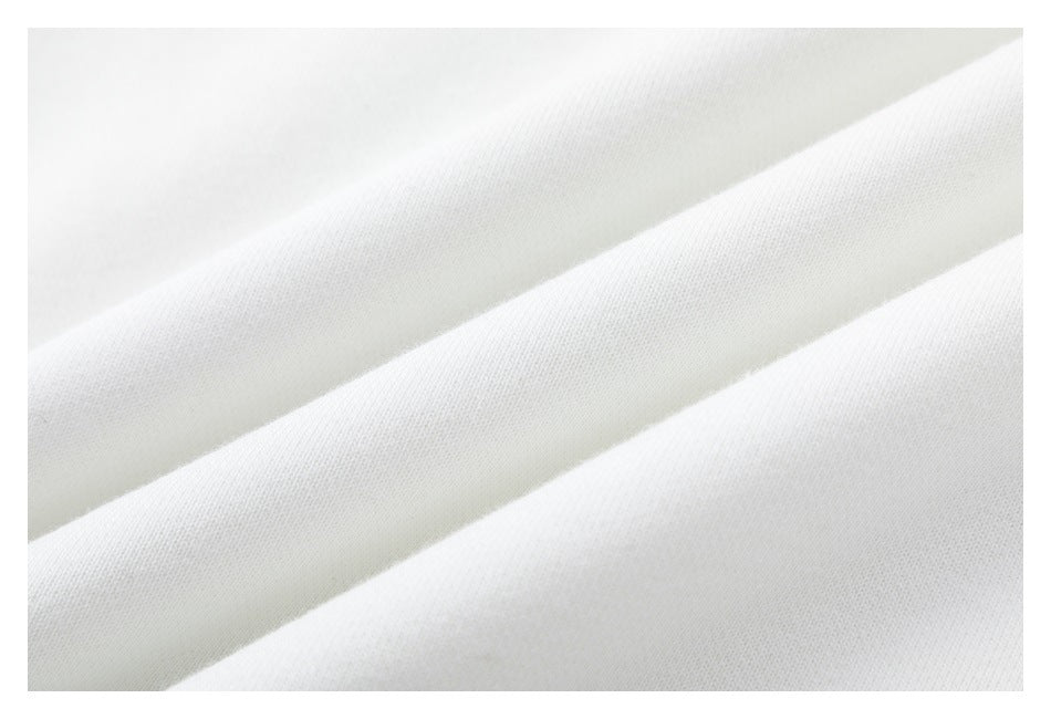 Macro view of the white sweatshirt fabric arranged in soft folds.