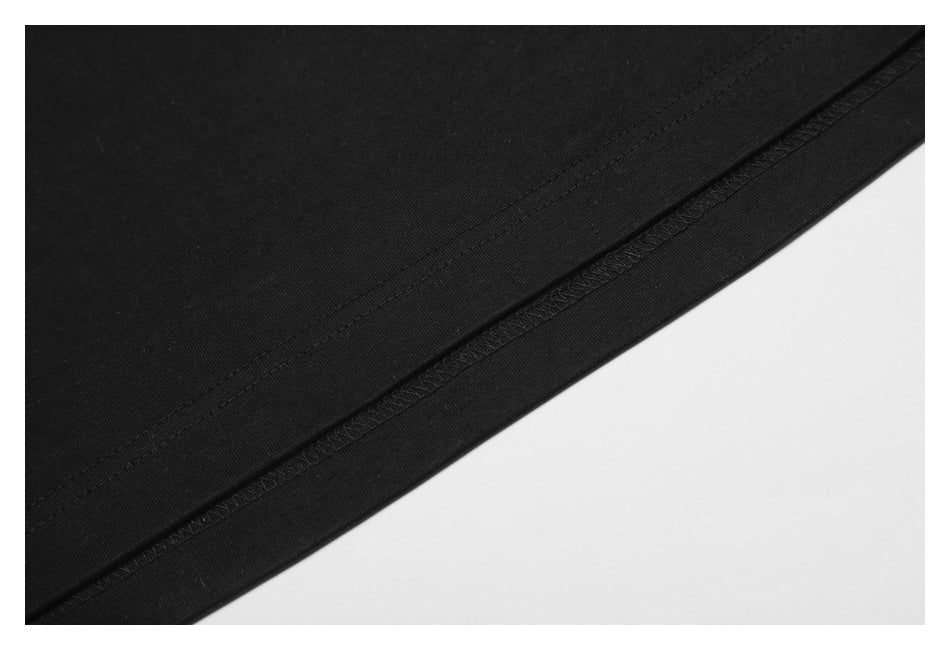 Close-up of the black shirt's bottom hem and parallel stitching.