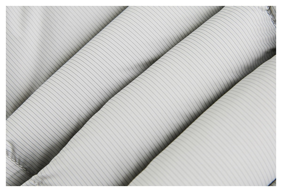 Close-up of light gray fabric with fine, evenly spaced dark pinstripes.