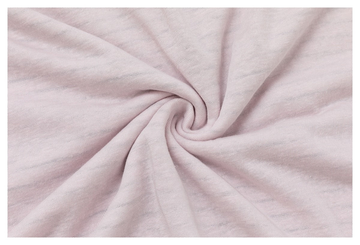 Close-up of pale blush fabric gathered into a spiral, showing its fine knit texture.
