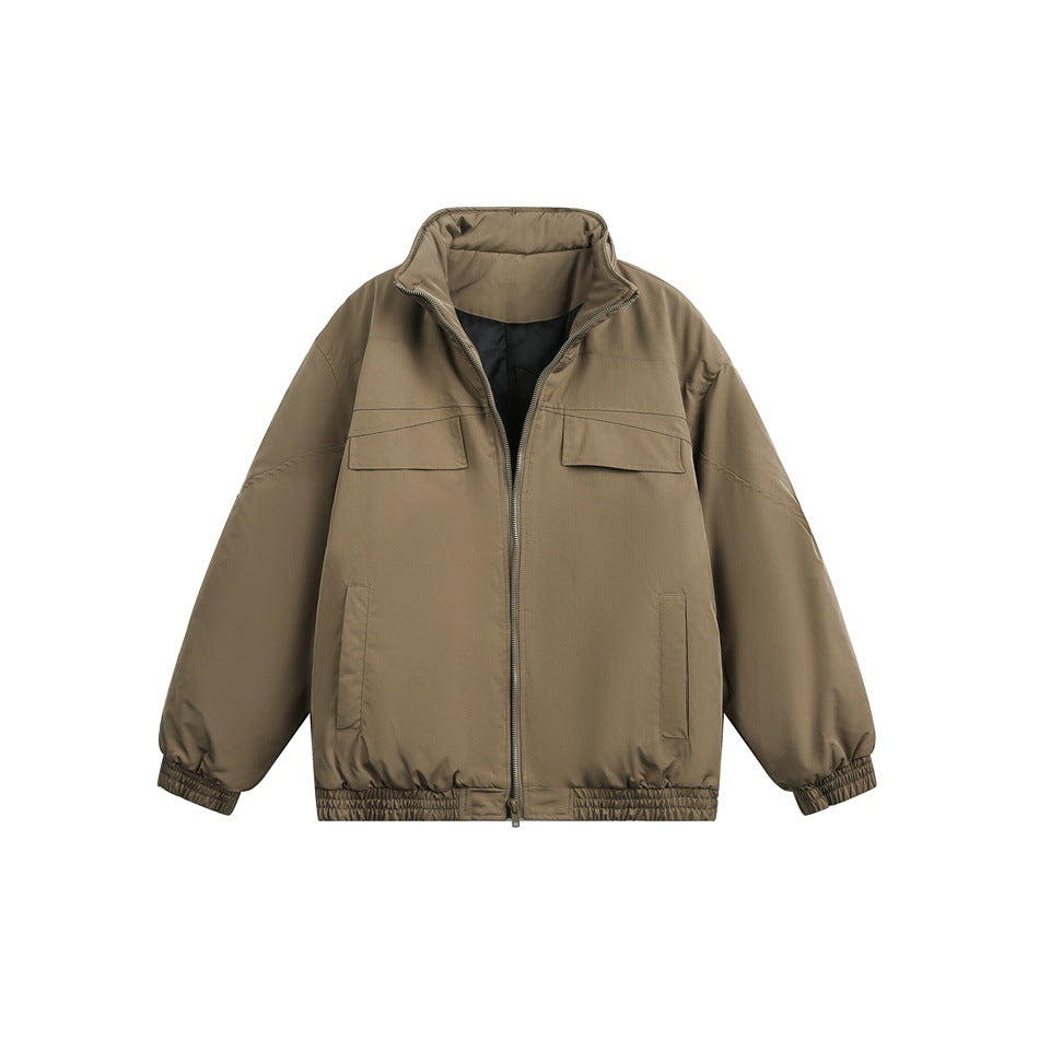 Front view of a taupe jacket with a high collar, zip closure, chest flap pockets, and elasticated cuffs and hem.