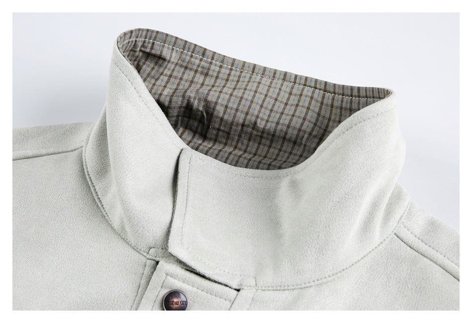 Close-up of an off-white coat collar with blue, tan, and brown plaid lining.