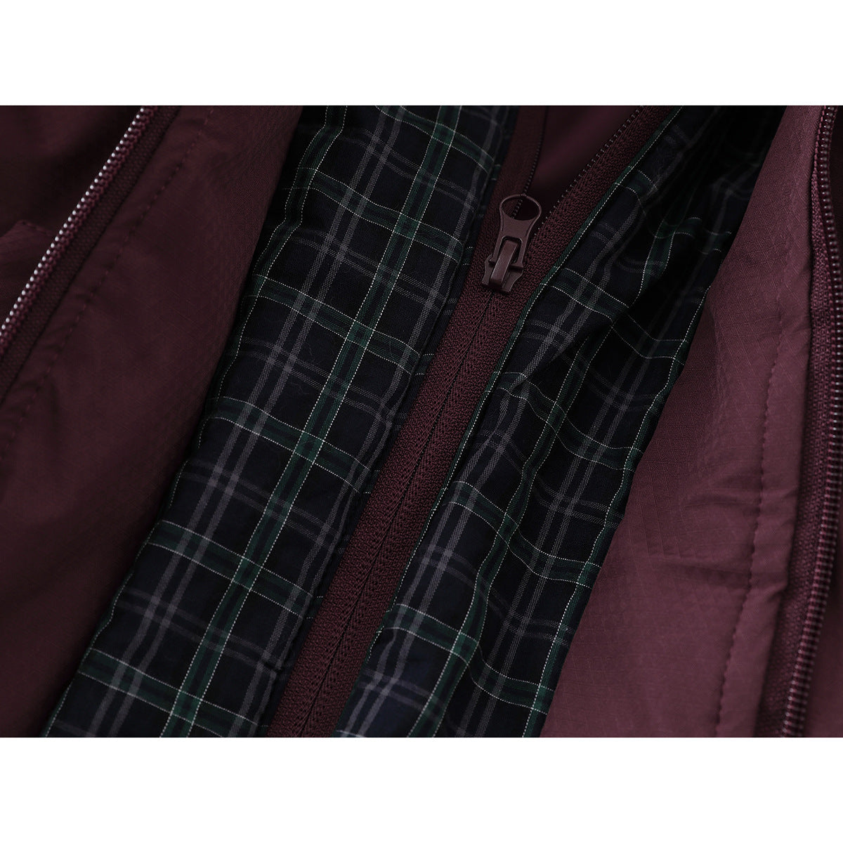 Close-up of the jacket's dark plaid inner lining, burgundy zipper, and burgundy outer fabric.