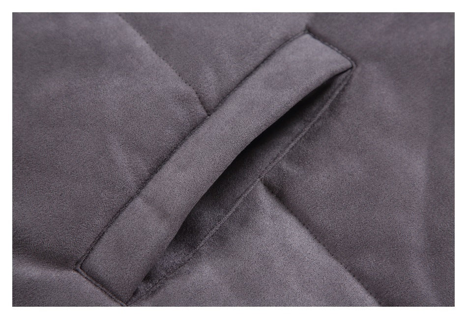 Close-up of a slanted welt pocket opening on charcoal gray jacket fabric.
