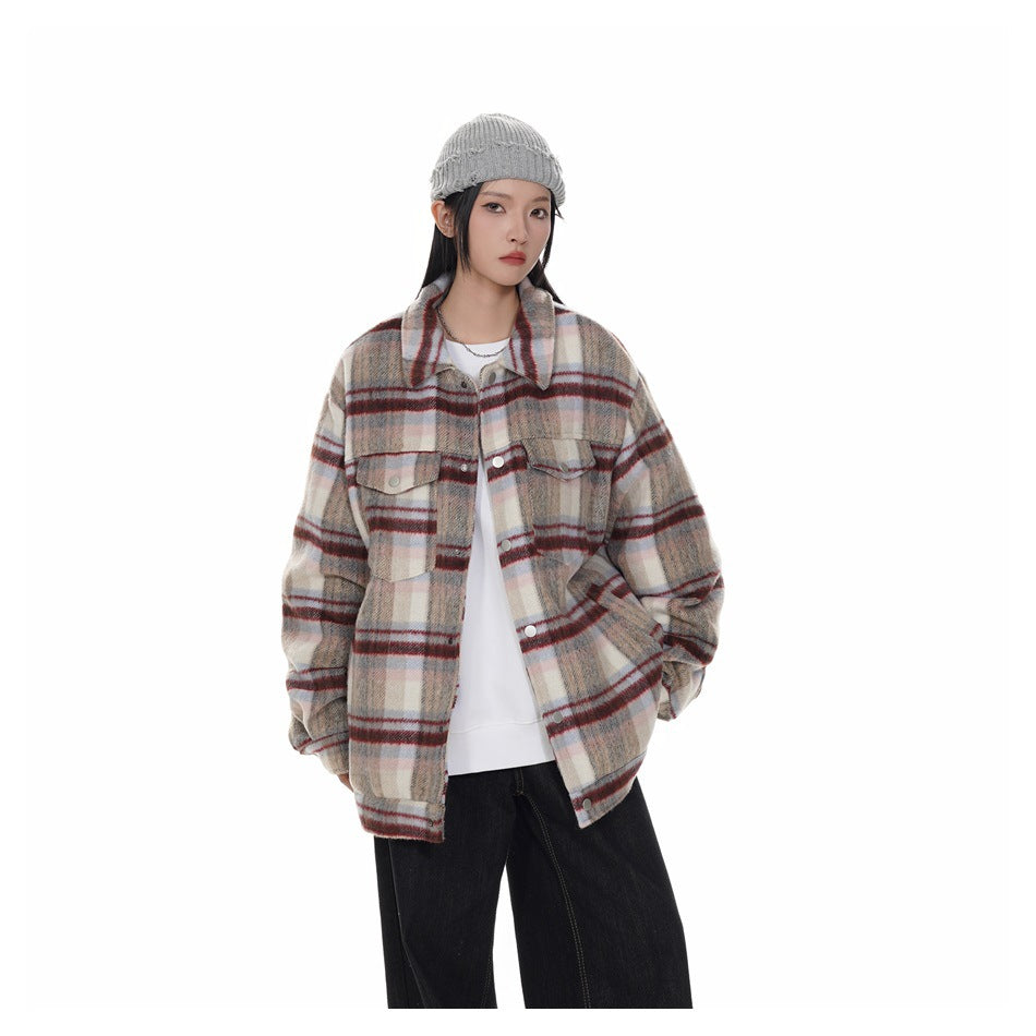 Model wearing an oversized beige, gray, and burgundy plaid button-front jacket over a white top.