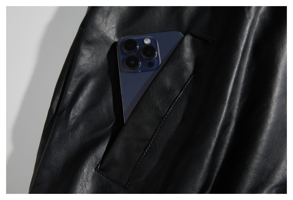A phone tucked into the angled pocket of a black jacket.