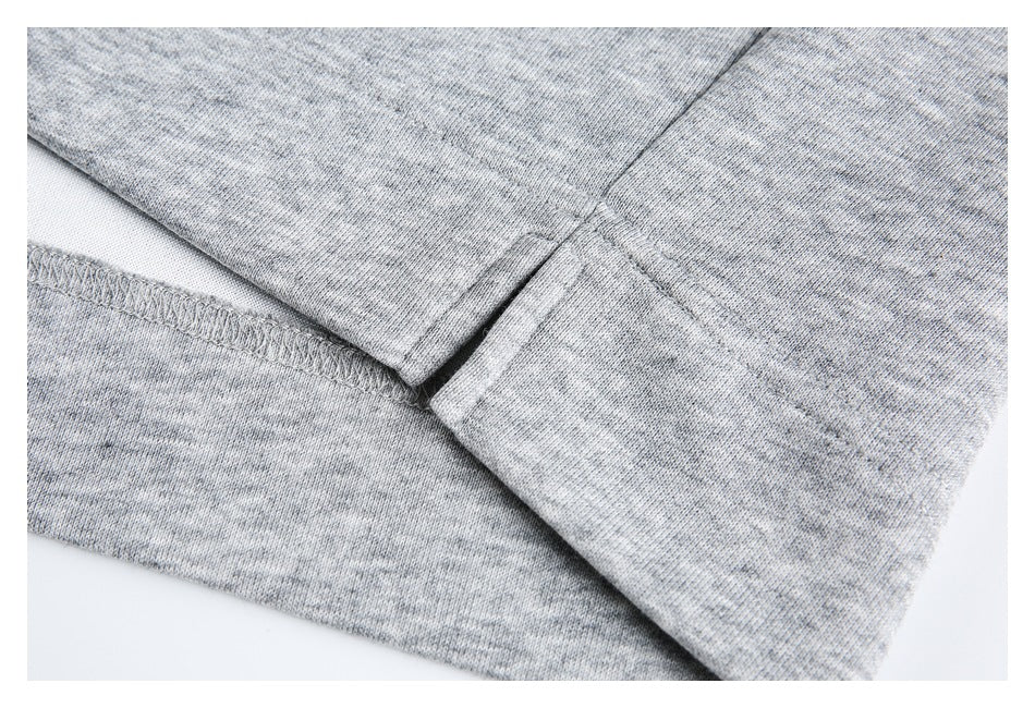 Close-up of stitching and seam construction on gray fabric.