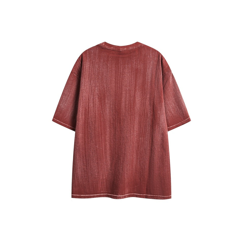 Back view of a muted red oversized short-sleeve T-shirt laid flat against a white background.