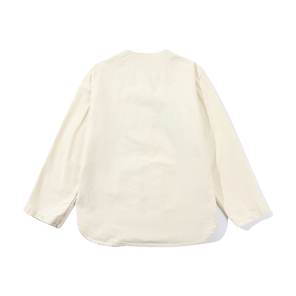 Back view of an ivory long-sleeved shirt with a rounded hem and buttoned cuffs.