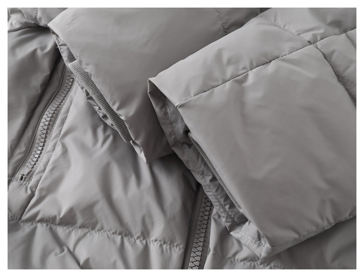 Close-up of a gray padded jacket sleeve with a wide cuff tab and hook-and-loop fastening.