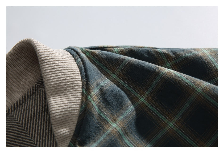 Close-up of the cream ribbed collar and dark green plaid jacket shoulder.