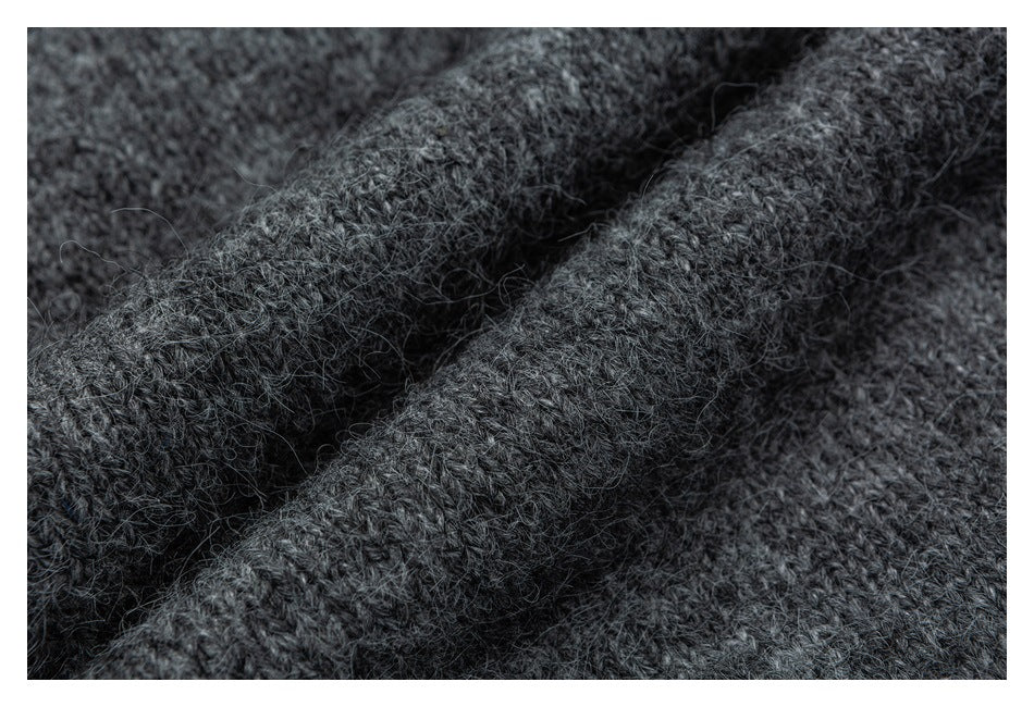 Macro view of fuzzy charcoal-gray knit stitches and fibers.