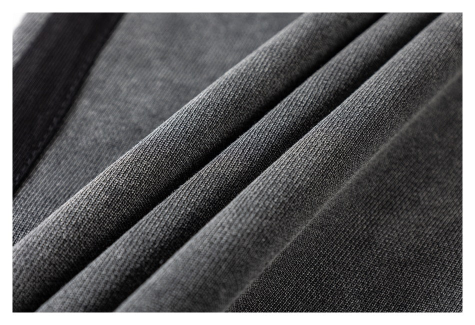 Macro view of the charcoal gray fabric's ribbed texture and folded edges.