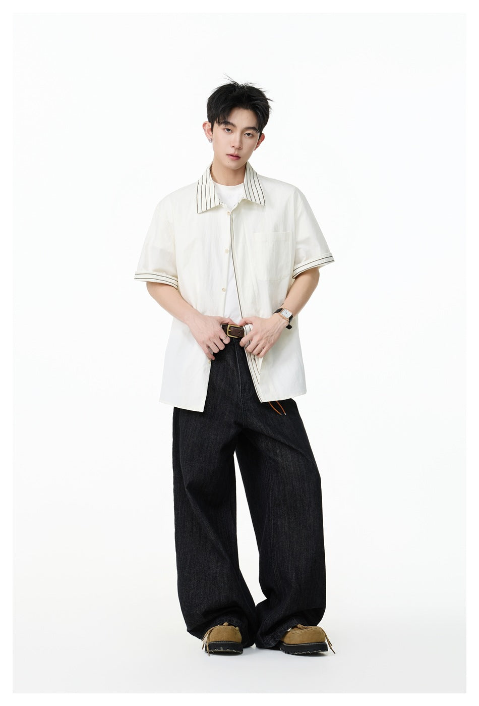 Model wearing an ivory short-sleeve button-up shirt with a fine striped collar and sleeve cuffs.