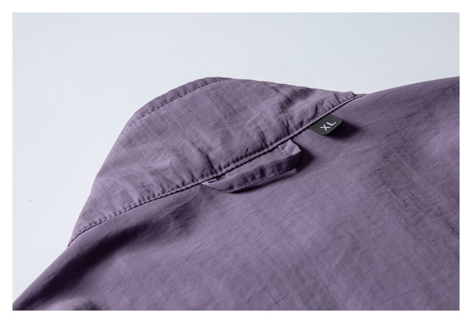 Close-up of a purple garment shoulder seam and small XL size tab.