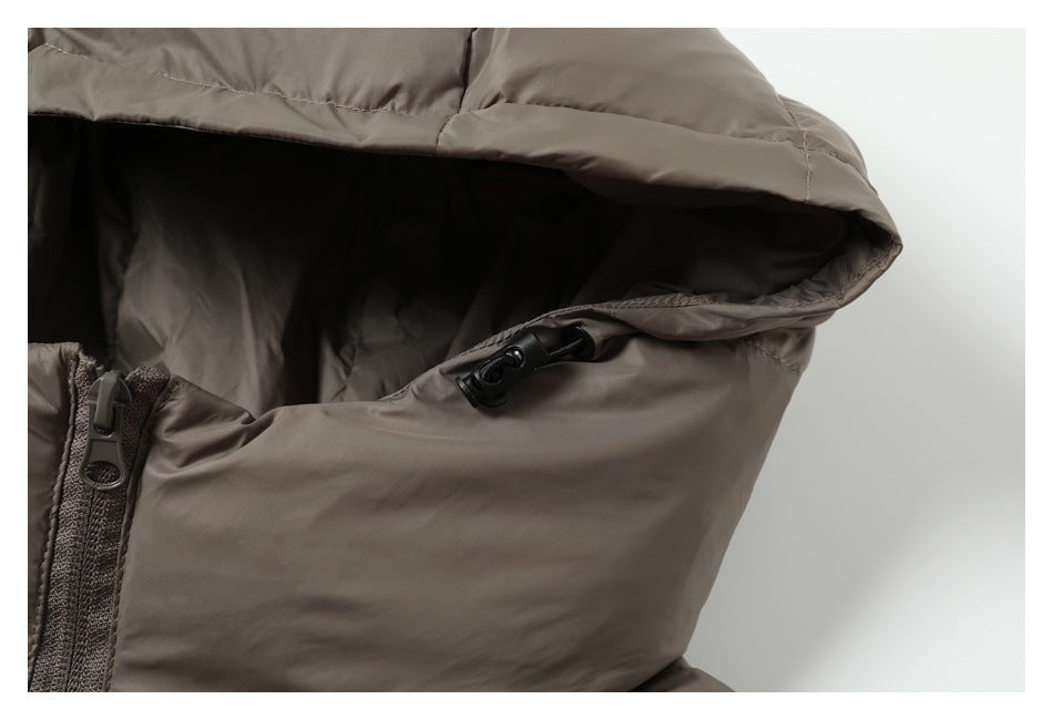 Close-up of the taupe jacket hood with a black drawcord toggle and part of the front zipper.