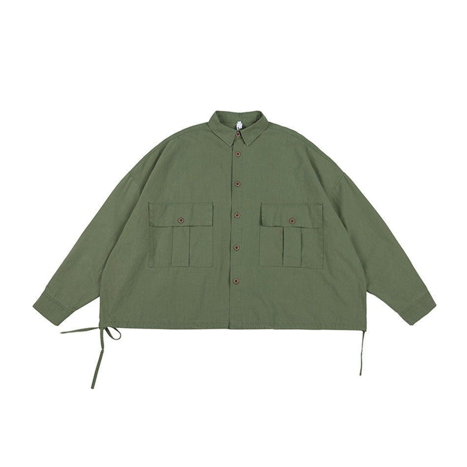 Army green button-front shirt-jacket flat lay with two flap chest pockets and side hem drawstring ties