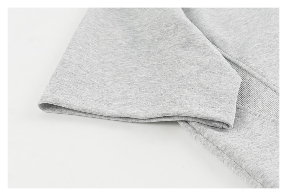 Close-up of a heather-gray garment's short sleeve and stitched sleeve opening.