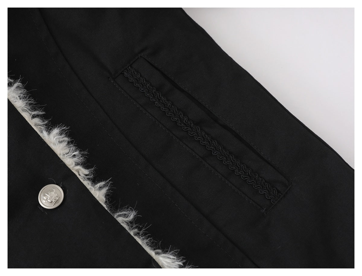 Close-up of a black coat pocket with decorative black braid, white fuzzy edge trim, and a silver button.