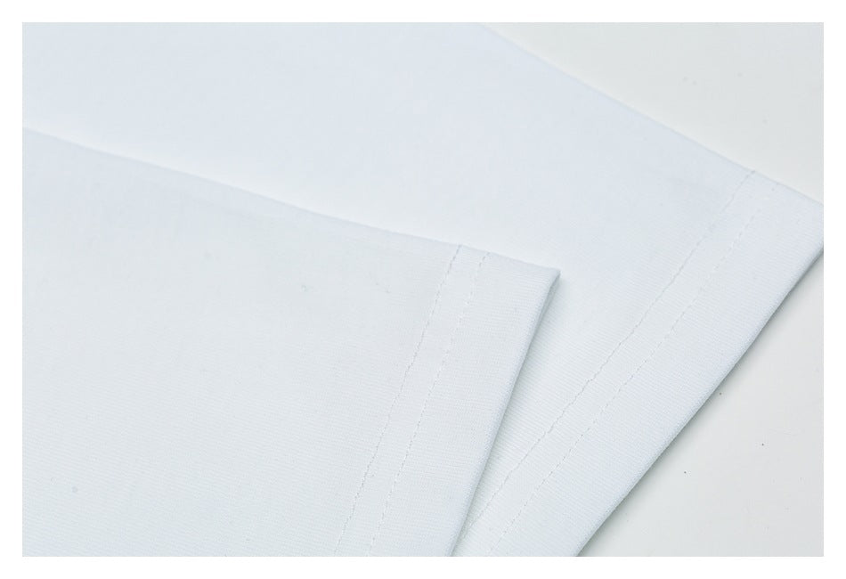 Close-up of folded white fabric edges with parallel stitched hems.