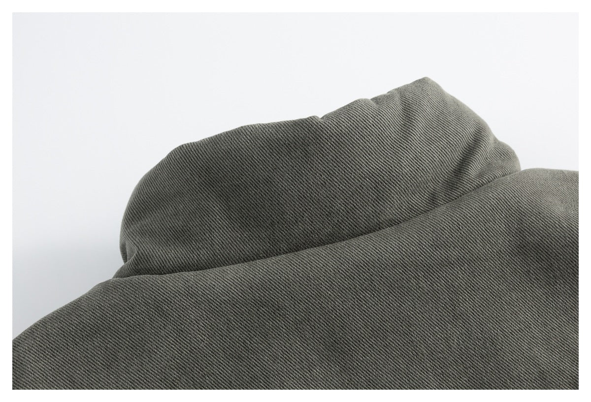 Close-up of the olive-gray jacket collar and diagonal twill surface.