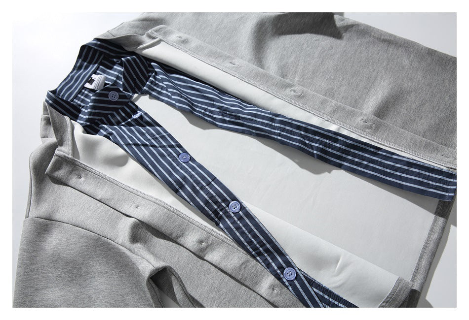 Inside view of a gray top with a navy striped button-front layer and white inner panel.