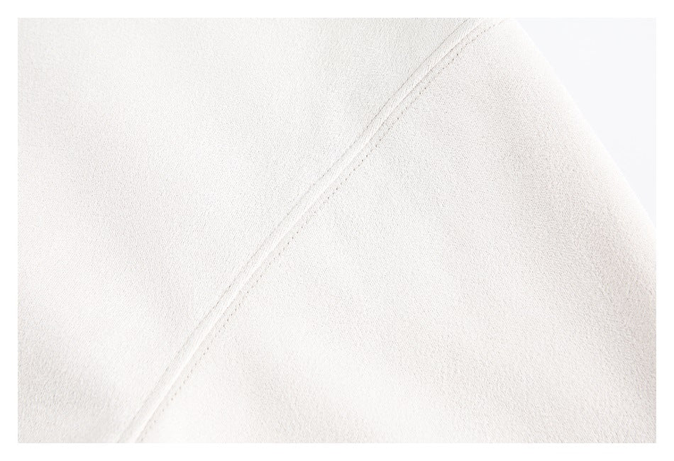 Close-up of pale cream fabric with a diagonal stitched seam.