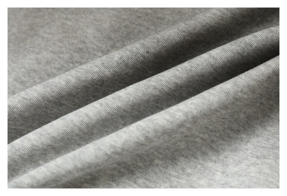 Close-up of the heather gray garment fabric arranged in soft folds.