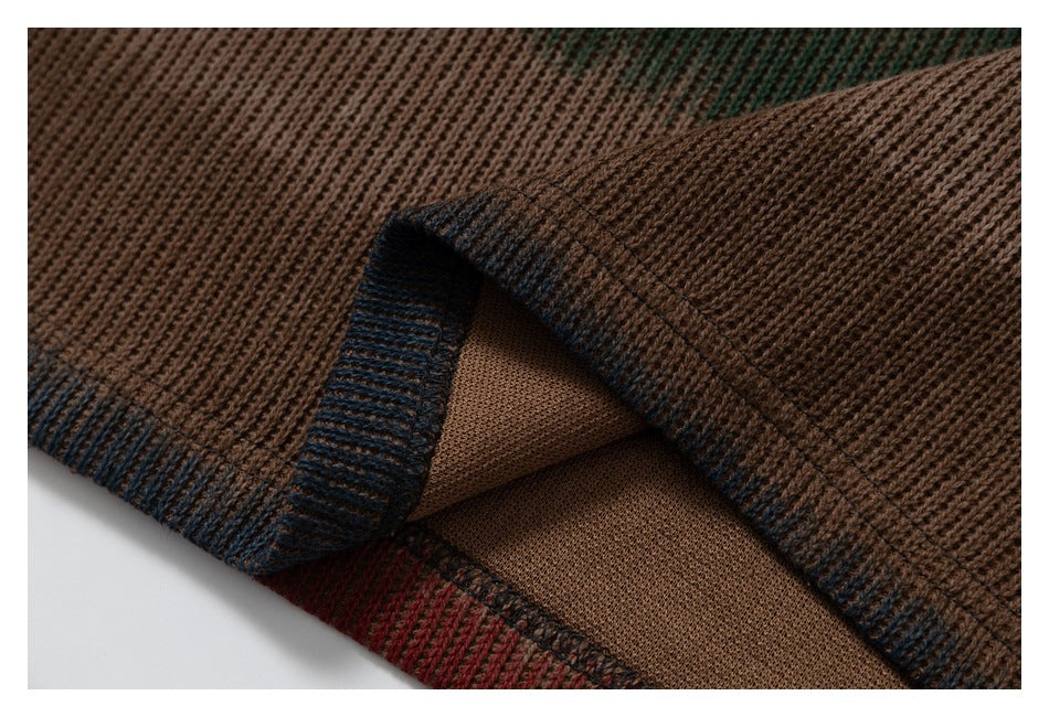 Folded brown rib-knit hem showing its tan inner side and dark blue and red edging.