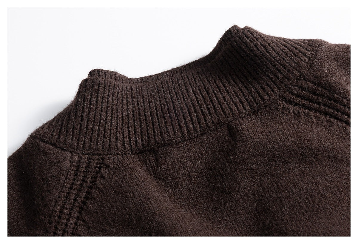 Close-up of a dark brown knit garment's tall ribbed collar and shoulder seam.