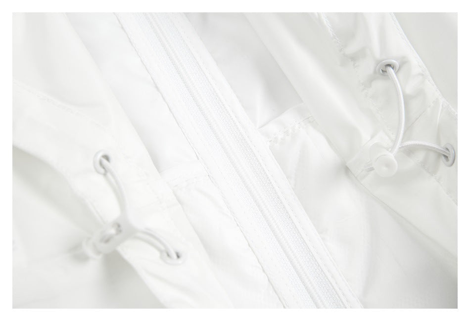 Close-up of a white zipper and adjustable drawcords with metal eyelets on a white garment.
