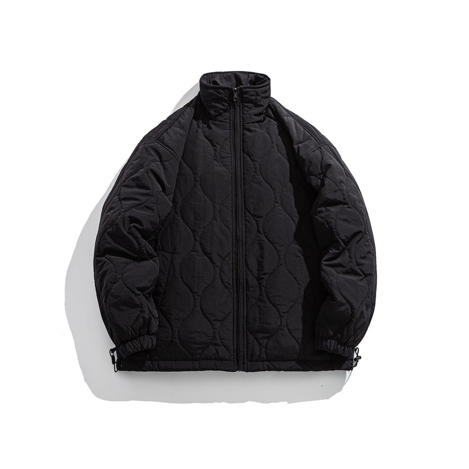 Black quilted stand-collar zip jacket laid flat with wavy quilting and elasticated cuffs