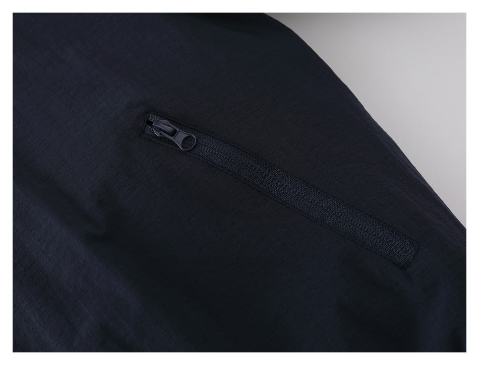 Close-up of a black zipper pocket on dark navy textured fabric.
