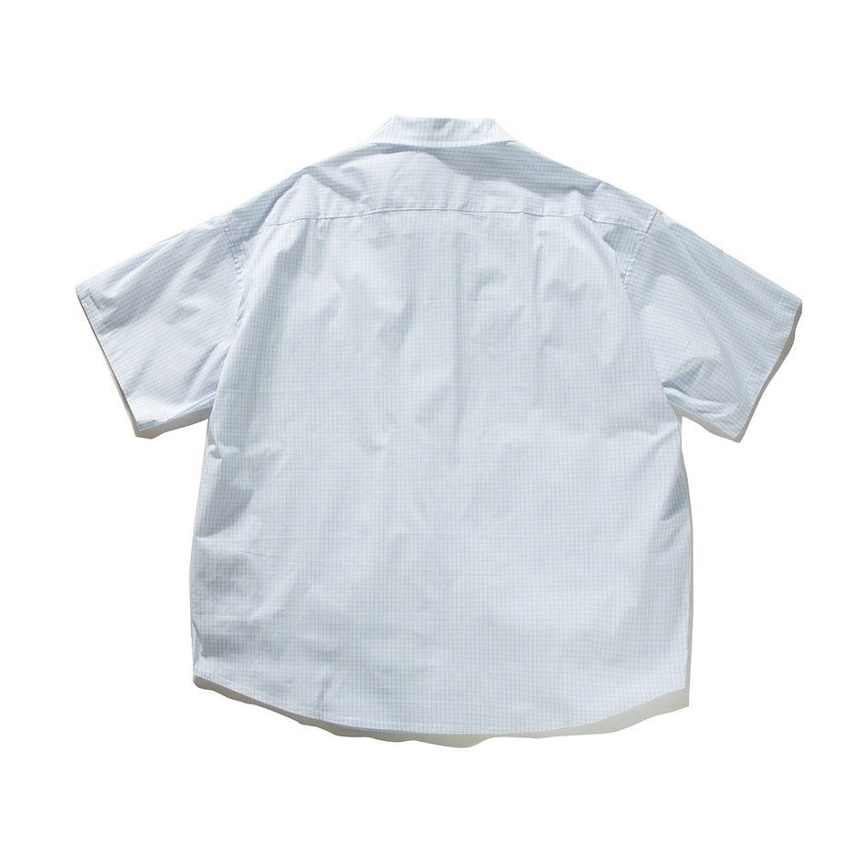 Back view of white short-sleeve shirt with light blue grid check and back yoke seam, flat lay