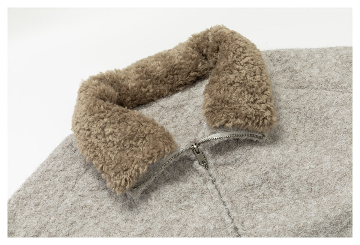 Close-up of the light beige jacket's taupe fuzzy collar and front zipper.